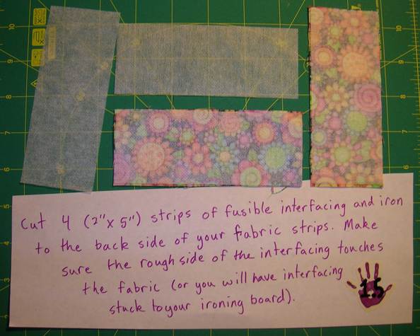 Image for Step 1.5. Cut 4 strips of fusible interfacing (2 inches by 5 inches), and iron them to the back site of your fabric strips. Make sure the rough side of the interfacing touches the fabric (or you will have interfacing stuck to your ironing board).